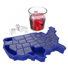 an ice cube tray with a drink in it next to a map of the united states