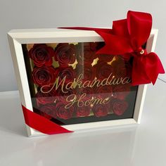 there is a box with red roses in it and a ribbon on the front that says, makraduva home