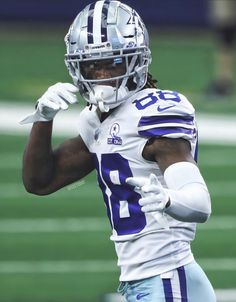 a close up of a football player wearing a uniform and holding a ball in his hand