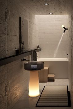 a bathroom with a sink, toilet and bathtub next to a shower head light