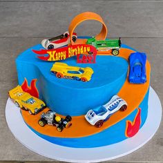 a birthday cake with cars and trucks on it