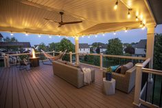 a deck with lights and furniture on it