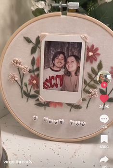 an embroidered photo frame with flowers and the words i love you