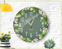 a clock on the wall with plants and potted plant next to it, in front of a white brick wall