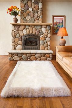 a living room with a fireplace and white rug