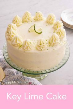 a cake with white frosting sitting on top of a glass plate