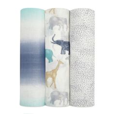 three baby swaddles with elephants and giraffes on them in various colors