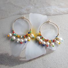 Rainbow earrings, colorful earrings, beach jewelry, big hoop earrings, modern jewelry, mothers day gift, freshwater pearl hoop earrings, wire wrapped earrings, cute earrings, summer jewelry, unique earrings, rainbow jewelry, 24K gold filled hoop. Modern trendy beach jewelry. These rainbow earrings look like a piece you might pick up on vacation. Wear them with everything from a T-shirt and jeans to your favorite swimsuit. HIGH QUALITY MATERIALS / SIZE 24-karat gold filled 20mm hoops wire wrapped Handmade Rainbow Hoop Earrings For The Beach, Colorful Hoop Earrings For The Beach, Rainbow Drop Earrings For The Beach, Rainbow Drop Earrings For Beach, Colorful Handmade Hoop Earrings For Beach, Summer Beach Multicolor Hoop Earrings, Rainbow Beaded Dangle Hoop Earrings, Rainbow Hoop Earrings With Colorful Beads, Rainbow Colorful Beaded Hoop Earrings