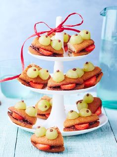 three tiered trays with cookies and pastries on them sitting on a table