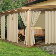 a patio covered with curtains and furniture