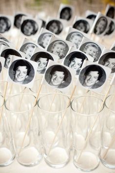 an arrangement of glasses with pictures on them and toothpicks sticking out of them