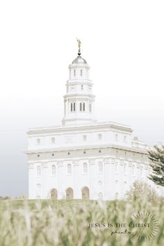 a tall white building with a statue on top