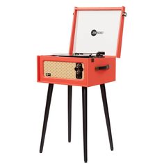 an orange record player with black legs