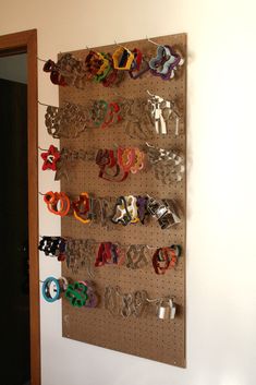 a wall mounted shoe rack with many pairs of shoes hanging from it's sides