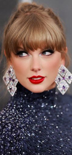 a woman with red lipstick and big earrings