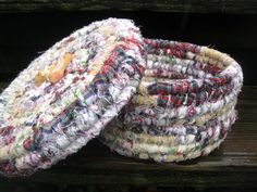 two pieces of fabric sitting on top of a wooden bench