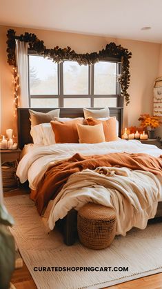 a large bed sitting in a bedroom next to a window with candles on the windowsill