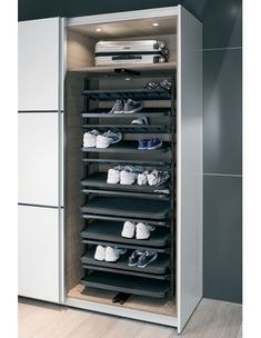 a large white cabinet with many pairs of shoes in it