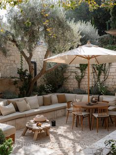 an outdoor seating area with tables and umbrellas