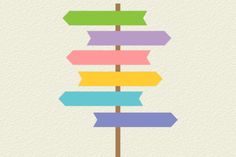 an arrow sign with multiple colored arrows pointing in different directions on a wooden stick against a white background