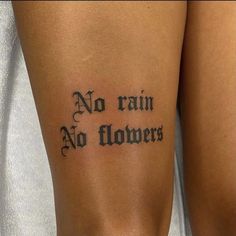 a woman with a tattoo on her leg that says no rain, no flowers