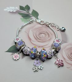 Daisy flowers, Bracelet Pandora style, Pandora Style flowers Charm Bracelet, bracelet is  enhanced with the exclusive mix  of Beads and charms. This is an daisy flower theme Bracelet. Cute beaded bracelet. These lovely daisy charm bracelets are made of high quality glass,  DAISY CHARM BRACELET : The multi-color crystal stones are dazzling, and the delicate and lovely daisy makes the charm bracelet more beautiful, perfect to spice up any outfit, no matter if it is casual or formal. for any special occasions dinner party, birthday party, wedding, festival celebration, graduation, concert, anniversary, dancing ball, baby shower, beach funny, prom, formal events and so on, even everyday wear. Adjustable Flower Charms Bracelets, Adjustable Flower-shaped Charm Bracelets, Adjustable Flower-shaped Bracelets With Charms, Flower Charm Bracelet As A Gift, Silver Beaded Bracelets With Flower Charm, Pink Flower Charm Bracelet For Jewelry Making, Pink Beaded Flower Charm Bracelet, Adjustable Flower Charm Bracelet, Flower Shaped Crystal Bracelet For Jewelry Making