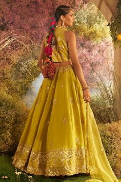 Yellow flared lehenga in silk chanderi base with fleur embroidery using gold accents. Paired with a halter neck blouse with all over fleur bloom embroidery and kiran lace border embellished dupatta. - Aza Fashions Silk Lehenga With Pallu, Traditional Chanderi Lehenga, Sleeveless Lehenga With Zari Work For Festive, Traditional Sleeveless Chanderi Lehenga, Chanderi Lehenga With Zari Work, Sleeveless Lehenga With Pallu For Eid, Sleeveless Silk Lehenga With Dupatta, Anarkali Style Sleeveless Chanderi Lehenga, Sleeveless Chanderi Lehenga For Navratri