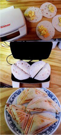 there are several different types of food on this plate and in the background is an electric sandwich maker