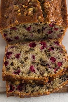 a loaf of cranberry walnut bread is cut into slices