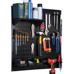 a black pegboard with tools hanging on it