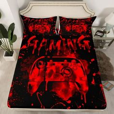 a bed covered in red and black paint with a video game controller printed on it