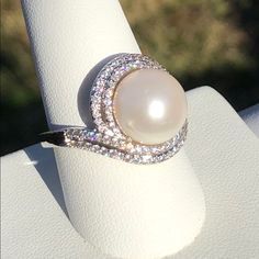 Genuine Freshwater Pearl Silvertone Ring Surrounded By Two Rows Of Simulated Diamond Which Are White Faceted Cz's 1.13 Cts, 96 Count. Nwot Only Reasonable Offers Will Be Considered And Are Encouraged White Pearl Ring With Diamond Accents, Elegant Diamond White Rings With Rhinestones, Diamond White Pearl Ring For Anniversary, White Pearl Rings With Diamond Accents, White Rhinestone Promise Ring, Fine Jewelry White Rhinestone Jewelry, White Fine Jewelry With Rhinestones, Fine White Jewelry With Rhinestones, White Pearl Ring With Vvs Clarity For Wedding