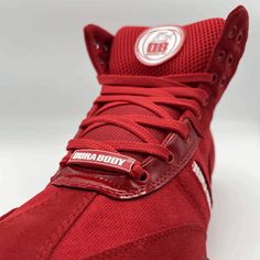 a red sneaker with white lettering on the upper and bottom part of the shoe