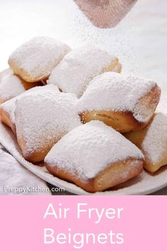 powdered sugar sprinkles are being poured onto pastries on a plate