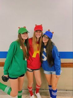 three girls in costumes posing for the camera