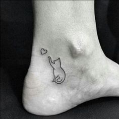 a cat with a heart tattoo on its foot