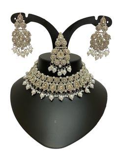 This Silver Jewelry Set exudes elegance and sophistication, making it a perfect choice for weddings, festive events, or grand celebrations. The intricate craftsmanship showcases delicate silver details adorned with Kundan and pearl accents, creating a regal and timeless appeal. Whether paired with traditional or fusion outfits, this stunning necklace and matching earrings add a touch of luxury to your ensemble. Available now with quick international shipping! About this Silver Asian Jewelry Set Bridal Silver Jewellery, Fusion Outfits, Kundan Work, Asian Jewelry, Kundan Necklace, Silver Jewelry Necklace, Jewellery Necklace, Silver Jewellery Sets, Kundan Necklaces