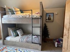 a bunk bed in a bedroom next to a christmas tree