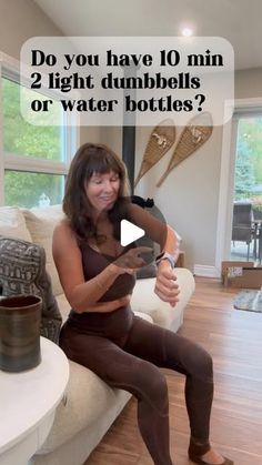 a woman sitting on top of a couch in front of a window with the caption do you have 10 min 2 light dumbbells or water bottles?