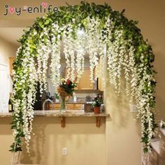 a bench covered in white flowers and greenery