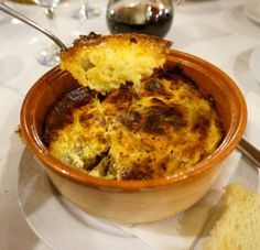 a bowl filled with food sitting on top of a table