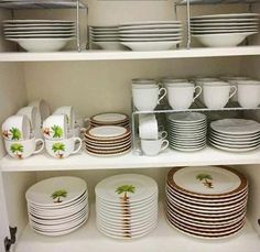 the shelves are filled with dishes and cups