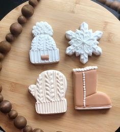 four decorated cookies sitting on top of a wooden table