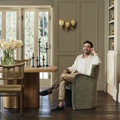 a man sitting in a chair next to a table