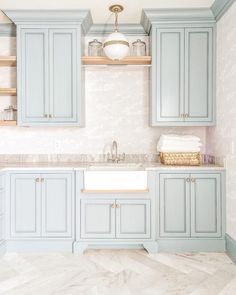 an image of a kitchen with blue cabinets and marble counter tops on instagram for the fox - group