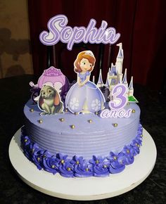 there is a birthday cake with princess and frog on it