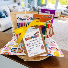 a basket filled with school supplies on top of a table