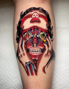 a person with tattoos on their legs holding their hands to their face