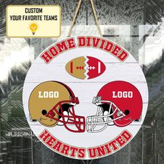 a wooden sign with two football helmets hanging from it's side and the words home divided hearts united