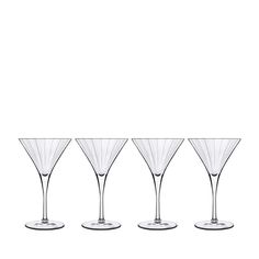 four empty wine glasses sitting next to each other